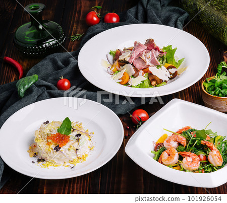 different salads in white plates on a wooden table different salads in white plates on a wooden table 101926054