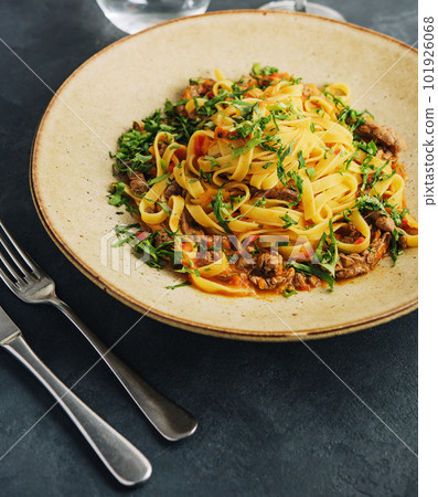 egg pasta tagliatelle with bolognese sauce made from meat and tomato sauce 101926068