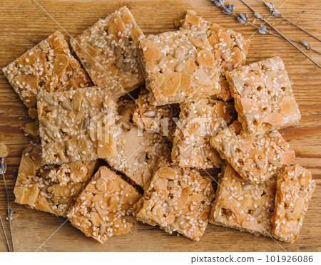 Multigrain cereal crunchy squares bars with pumpkin seeds on wooden background Multigrain cereal crunchy squares bars with pumpkin seeds on wooden background 101926086