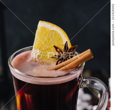 Winter hot drink mulled wine with cinnamon and lemon 101926092