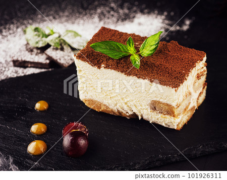 Tiramisu with grated chocolate and mint twig Tiramisu with grated chocolate and mint twig 101926311