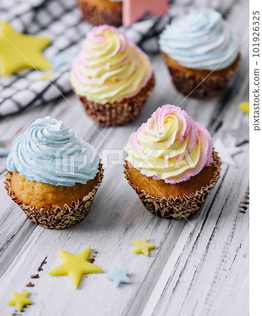 Delicious cupcakes with colorful cream on wood table Delicious cupcakes with colorful cream on wood table 101926325