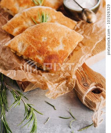 Delicious pies filo pastry with chicken, spinach and feta close-up on the table Delicious pies filo pastry with chicken, spinach and feta close-up on the table 101926329