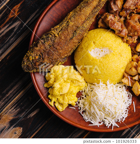 Traditional Moldavian hominy porridge on a wooden tray Traditional Moldavian hominy porridge on a wooden tray 101926333