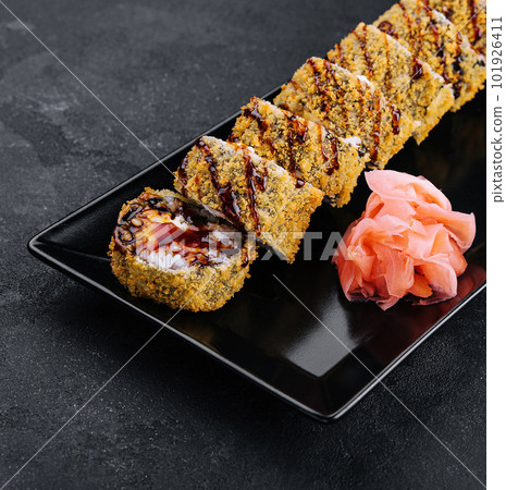 Served warm sushi with ginger and wasabi on a black stone plate 101926411