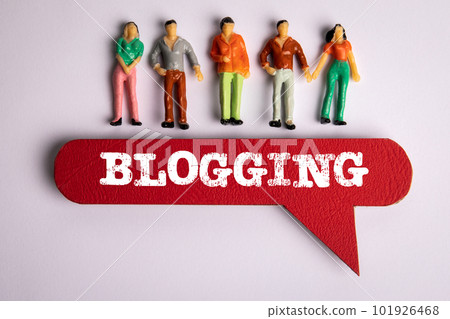 Blogging Concept. Red speech bubble with text and miniature figures of people on a white background Blogging Concept. Red speech bubble with text and miniature figures of people on a white background 101926468