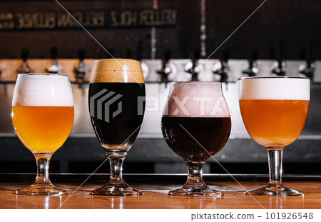 different types of craft beer in glasses on table in pub interior in daylight different types of craft beer in glasses on table in pub interior in daylight 101926548