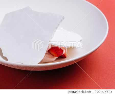 trendy meringue dessert with strawberries on plate 101926583