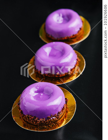 Mousse cakes from wild berries on plate 101926686