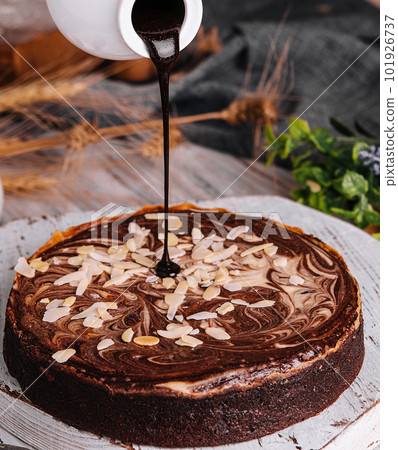Cocoa brownies pouring with melted dark chocolate Cocoa brownies pouring with melted dark chocolate 101926737