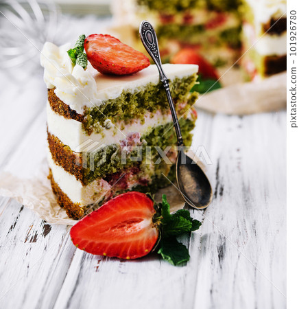 Green pistachio cake with strawberries closeup Green pistachio cake with strawberries closeup 101926780