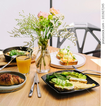 breakfast benedict, omelette with avocado bruschetta, and croissant 101927245