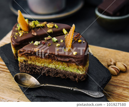 Slice pistachio cake on wooden board Slice pistachio cake on wooden board 101927580