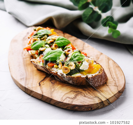 bruschetta with pesto, hazelnuts, cheese and basil bruschetta with pesto, hazelnuts, cheese and basil 101927582