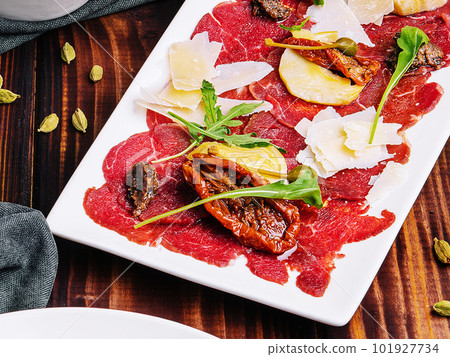 Carpaccio di manzo on white plate close up Carpaccio di manzo on white plate close up 101927734