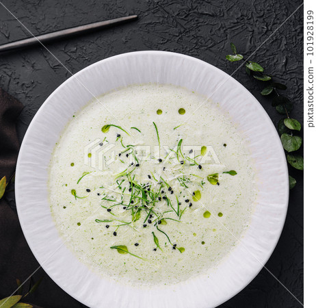 Champignon mushroom cream soup in white plate with pastry Champignon mushroom cream soup in white plate with pastry 101928199