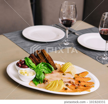White and red smoked fish slices with glasses of wine White and red smoked fish slices with glasses of wine 101928331
