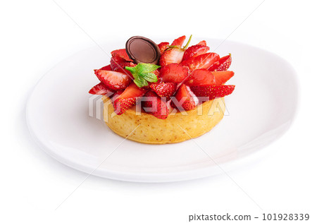 Tartlet with strawberry on white plate 101928339