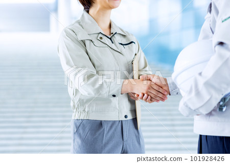 Men and women shaking hands in work clothes 101928426