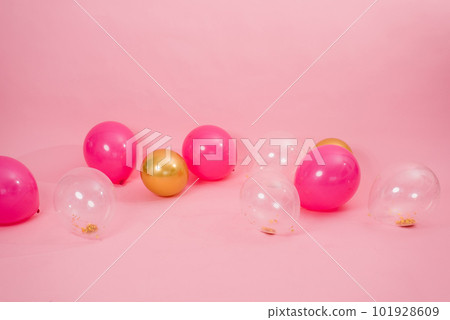 Beautiful multicolored pink, gold and transparent with confetti or sequins lie on a pink background in a chaotic order. Concept of Valentine's day, birthday, mother's day in barbiecore style 101928609