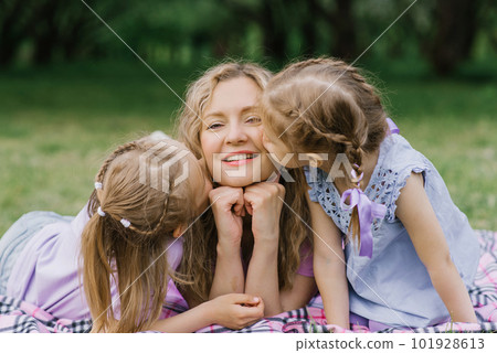 Daughters kiss happy mom on the cheeks Daughters kiss happy mom on the cheeks 101928613