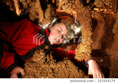 Spelunker admiring the stalacties 101929174