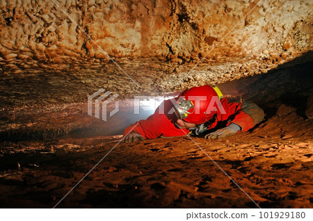 Narrow cave passage with a cave explorer Narrow cave passage with a cave explorer 101929180