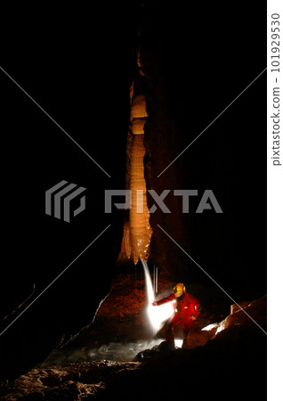 Spelunker exploring a cave Spelunker exploring a cave 101929530