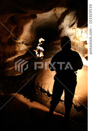 Cave passage with cave explorers 101929539