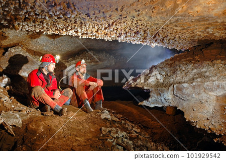 Two spelunkers in a cave Two spelunkers in a cave 101929542