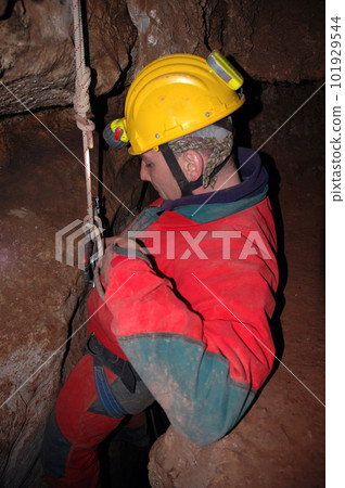 Caver abseiling in a pothole Caver abseiling in a pothole 101929544