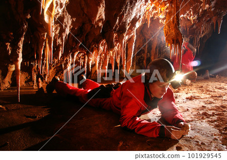Paleontolgist studying fossils in a cave 101929545