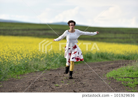 Young woman running on a countryside road. Freedom concept 101929636
