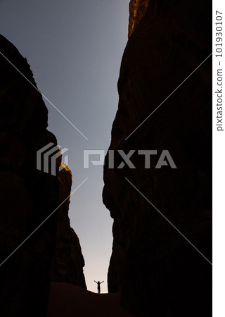 Amazing scale, silhouette of woman in a canyon 101930107