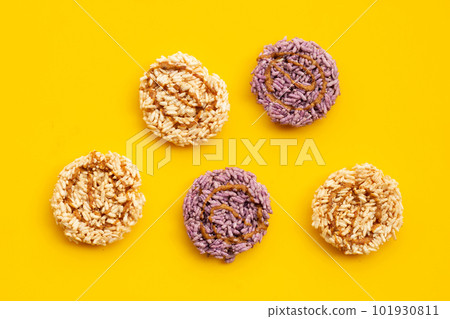Rice cracker with coconut palm sugar on yellow background. 101930811