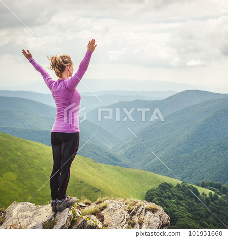 Young woman on the top of mountain 101931660