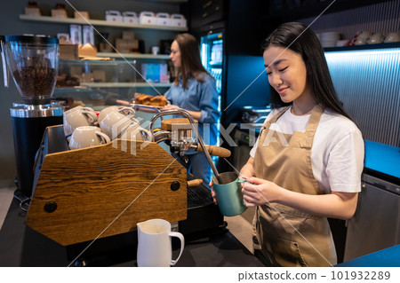Two females working together in a coffeehouse Two females working together in a coffeehouse 101932289