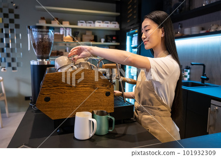Asian barista working in a coffee shop Asian barista working in a coffee shop 101932309