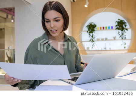 Focused company employee dealing with business documentation Focused company employee dealing with business documentation 101932436