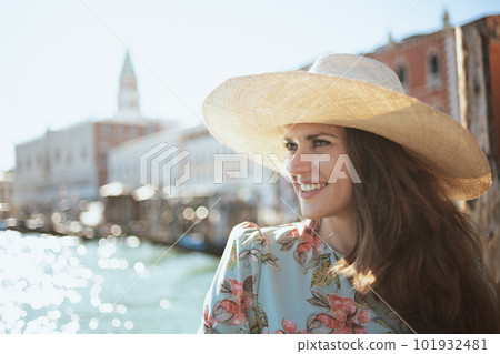 happy modern solo tourist woman in floral dress sightseeing 101932481