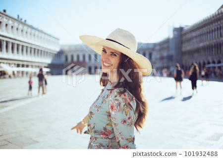 happy modern woman in floral dress exploring attractions 101932488