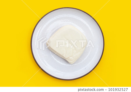 White tofu in plate on yellow background White tofu in plate on yellow background 101932527