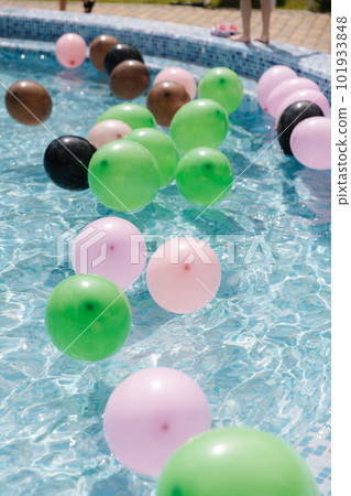 Lot of balloons in swimming pool. Preparation for summer pool party Lot of balloons in swimming pool. Preparation for summer pool party 101933848