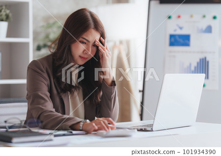 Accountant woman working on laptop and do document look stress, tax, exchange, research, accounting and Financial advisor concept 101934390