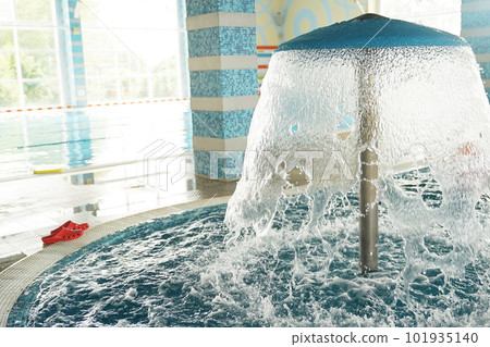 On the background of the panoramic window there is a swimming pool, and the roof from a decorative mushroom with a waterfall close-up. With space to copy. High quality photo On the background of the panoramic window there is a swimming pool, and the roof from a decorative mushroom with a waterfall close-up. With space to copy. High quality photo 101935140