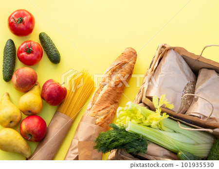 Fresh organic vegetables, greens and fruits on a yellow background. Ecological farm food concept. Top view. Flat lay. 101935530