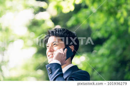 Businessman talking in nature Businessman talking in nature 101936279