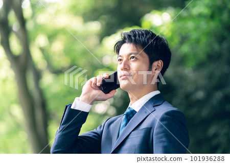 Businessman talking in nature Businessman talking in nature 101936288
