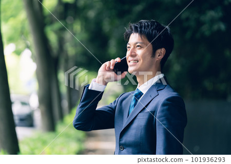 Businessman talking in nature Businessman talking in nature 101936293