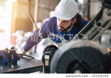 Engineer technician team service checking heavy industry machine robot welding arm head maintenance 101936349